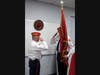 Neil Clark Sr. (L) passes Marine flag and command to new Commandant Mike Clark.