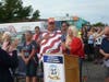Lisa Garner singing National Anthem with John Folz by her side