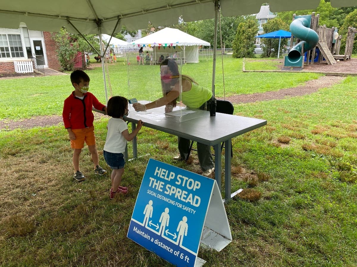 Pictured is a Madison Area YMCA MiniQuest Camper and a Kirby Preschool student, both from Madison, completing their health screenings upon arrival at the F.M. Kirby Children’s Center. 