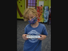 Julian Slusarz, age 6 from Madison displays his aluminum foil boat design.