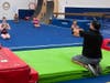 (L-R) Pictured are Madison Area YMCA gymnasts Elizabeth Gillen age 14 from Morristown, Mia Riddick and Erin Bolger both age 15 from Chatham, and Kelsey Greer age 14 from Madison with Gymnastics Head Coach Sergio Estrada during indoor studio gymnastics.