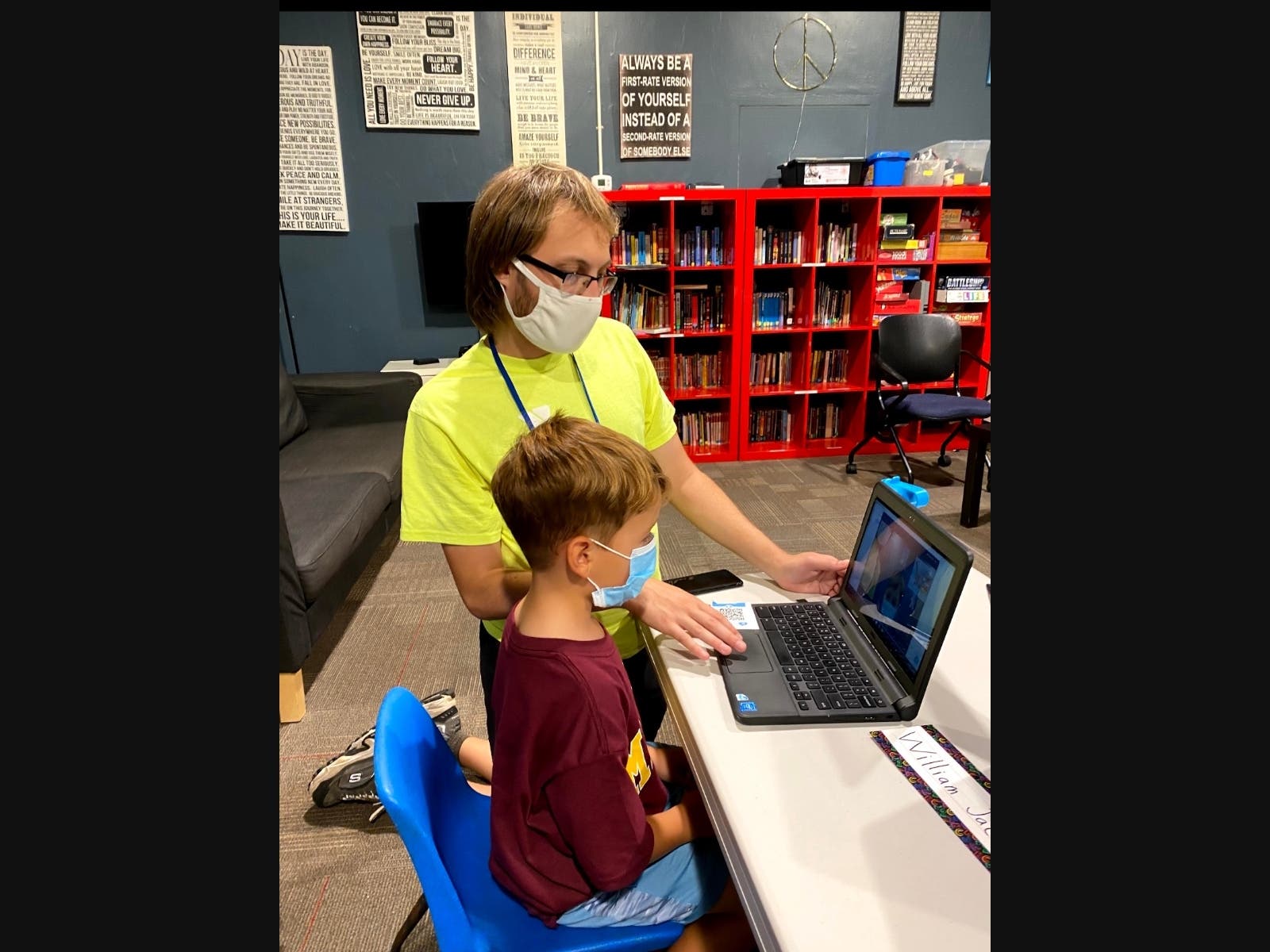 Pictured is Madison Area YMCA’s School-Age Virtual Learning Support Instructor Tyler Haupt from Madison, assisting Virtual Learning Support student William Jacobson, age 5, from Madison, with getting logged into his afternoon class with his kindergarten t