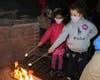 Kennedy Sobala age 5 from Cedar Knolls and Eliska Brading age 6 from Madison complete their Campfire Fun Patch by safely roasting marshmallows. 