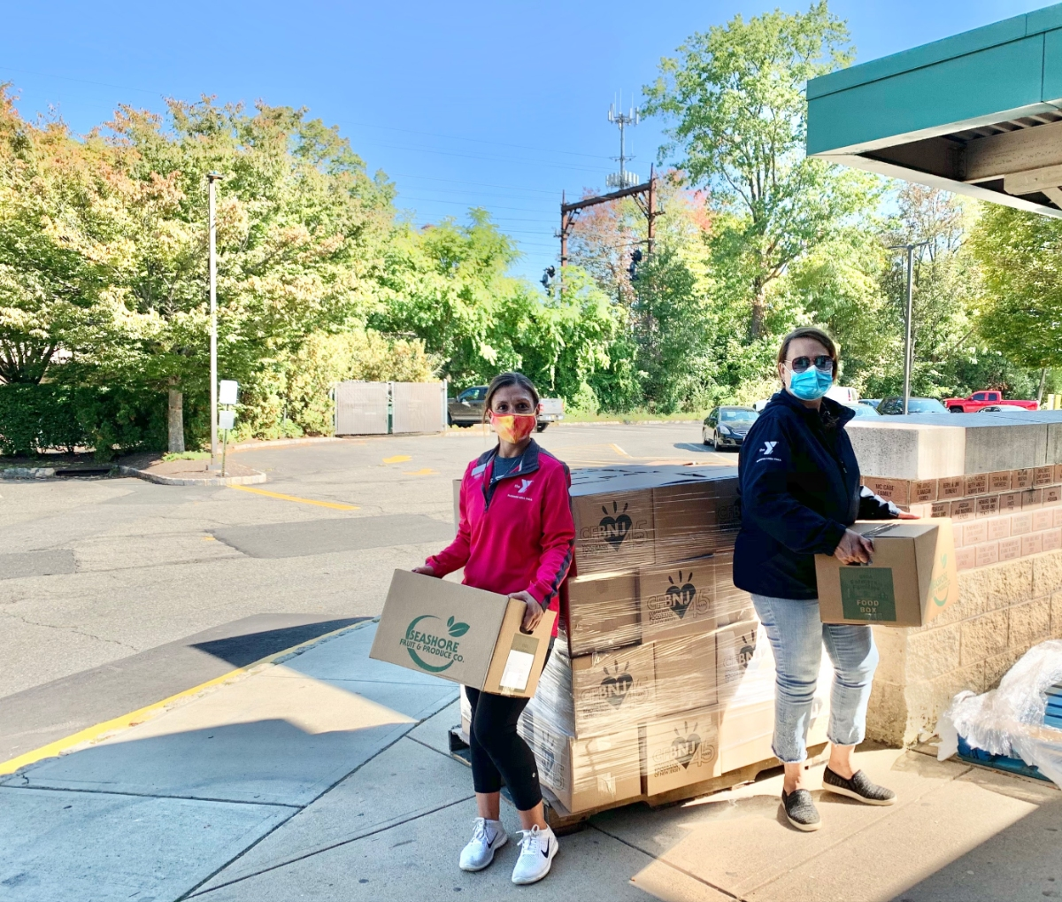 Pictured at the Madison Area YMCA’s Family Center are Director of Business Operations and Financial Assistance Coordinator Frances Roman and Associate Development Director Melissa DeSalvo organizing food boxes at the most recent Food Box Distribution day 