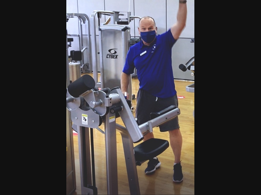 Pictured is Fitness Center staff Tom McNally of Florham Park, in the Madison Area YMCA’s new auxiliary Fitness Center located on the second floor of the Family Center at 111 King’s Road in Madison where he greets our members with a mask and smile.