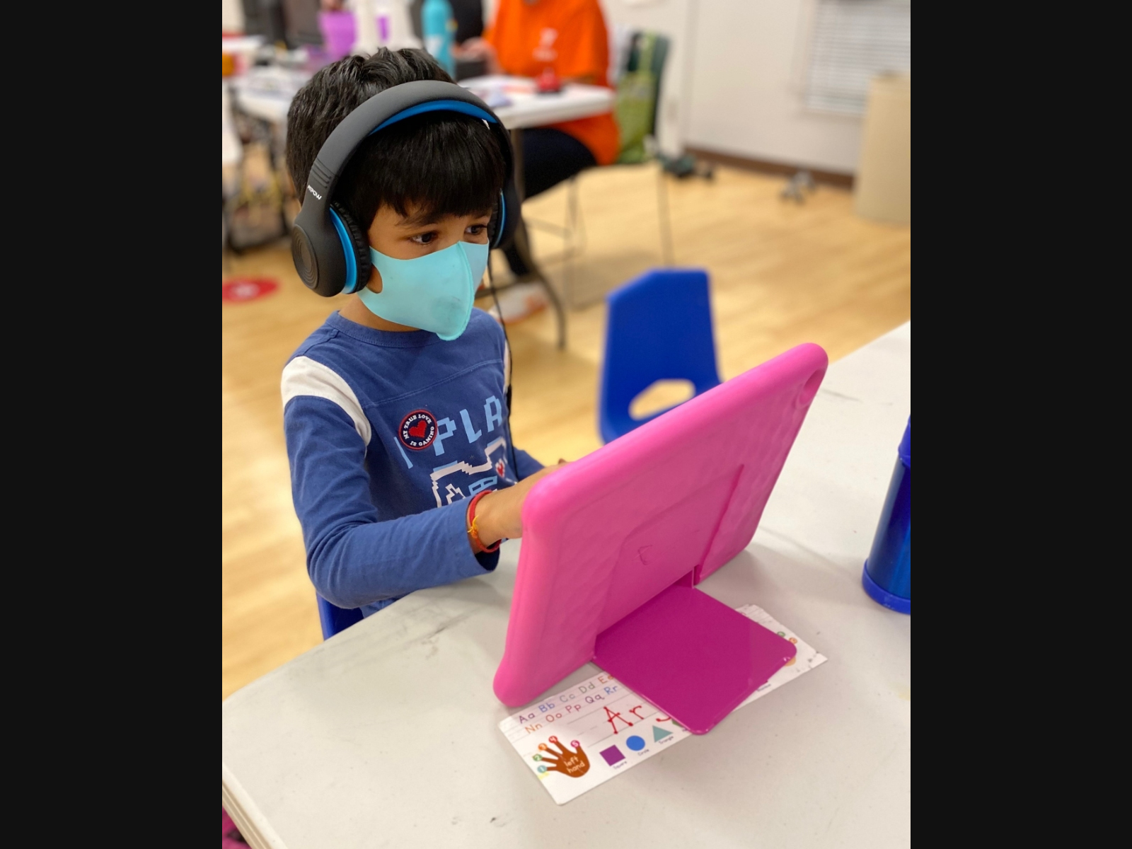 Pictured is Arjan Jain, age 5 from Summit, using a Fire HD 10 tablet and HD headphone set for virtual learning at the Madison Area YMCA.  