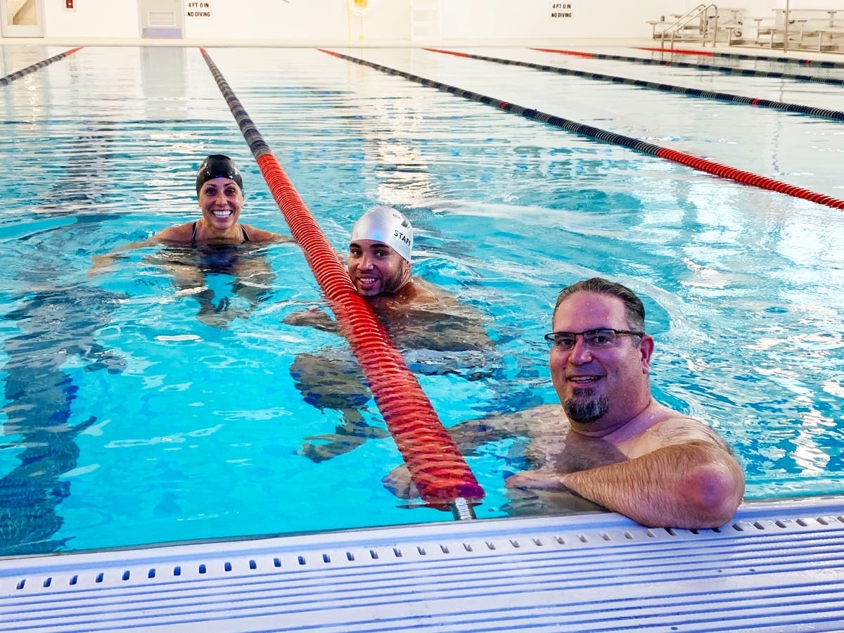 (L-R): Pictured is Assoc. Executive Director–Programs Kim Buccheri, Aquatics Program Director Yean Jimenez, and Sr. Aquatics Director & Mariners Head Coach Jon Siegel in the new 8-lane pool at the Madison Area YMCA’s new Walker D. Kirby Aquatics Center.