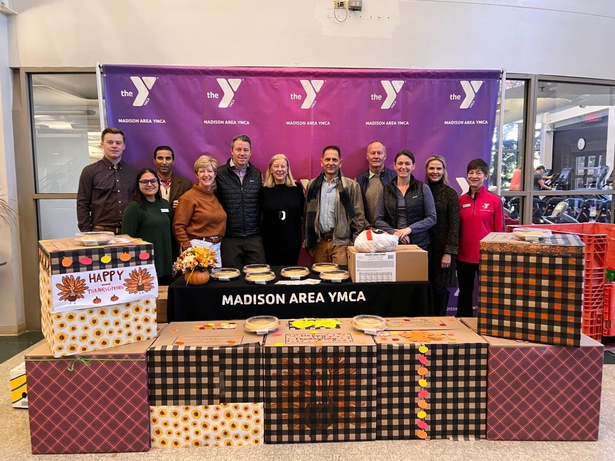 Members of the Oldendorp Group and the Madison Area YMCA come together to donate Thanksgiving dinners to those in need.