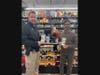 Pictured at Hickory Wine Cellar in Chatham Township: Chatham Township Police Juvenile Detective Jim Lattoz, Hickory Wine Cellar owners Hetal and Alpesh Ray.