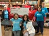 Giant employees (in the red shirts) and Warminster Food Bank volunteers (in the blue shirts) take a break from their work to pose with a $10,000 check from Giant Supermarket of Warminster to the Warminster Food Bank.