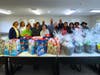 Members of the Hand & Stone corporate team pose with the completed baskets they assembled at NOVA’s Jamison office. The baskets and bags contain cleaning supplies, non-perishable food and personal care items for NOVA’s clients.