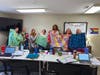 (Left to Right): NOVA Counselors Jee Soo Lee, Kevin Keller, Beth Hafft, Ashley Foley, Ray'ven Hudley, Sydney Finsel, and Jackie Carnation proudly display the fleece tie blankets donated by Women of Shir Ami that will be provided to NOVA clients.