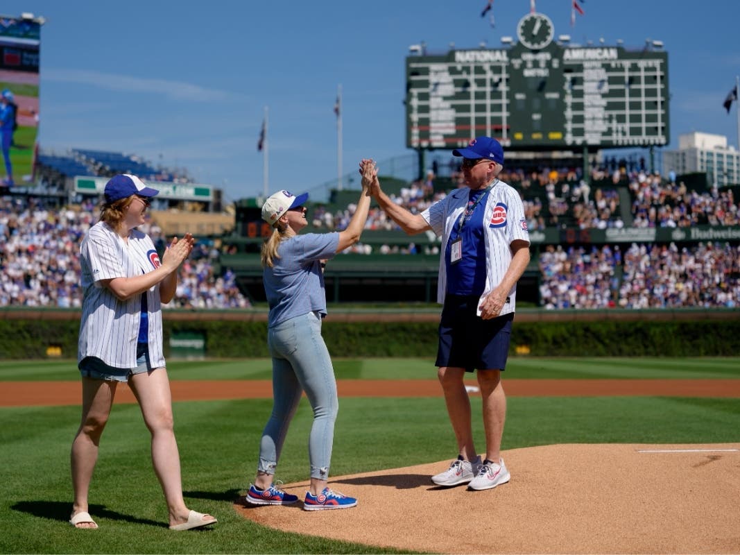 Carls Michels high fives one of his daughter after throwing out the ceremonial first pitch at Wrigley Field on Saturday, Sept. 12.