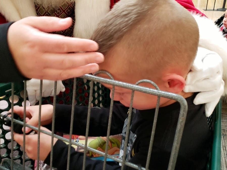 The Santa Claus at Gurnee Mills comforts Baiz, 8. 