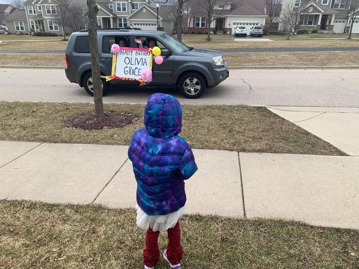 Olivia, 5, stands in front yard as neighbors, friends and family drive by to wish her a happy birthday on Friday, March 21, 2020.