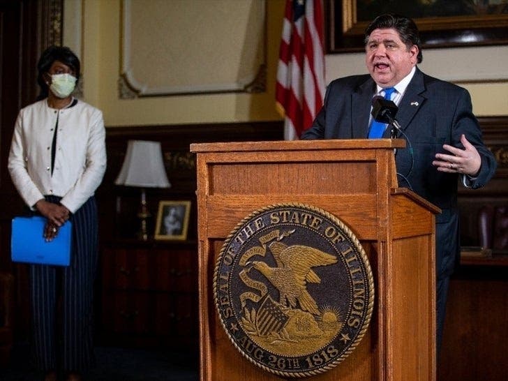 Illinois Gov. JB Pritzker answers questions from the media, along with Dr. Ngozi Ezike (left), director of the Illinois Department of Public Health, during his daily press briefing on the COVID-19 pandemic from his office at the Illinois State Capitol.