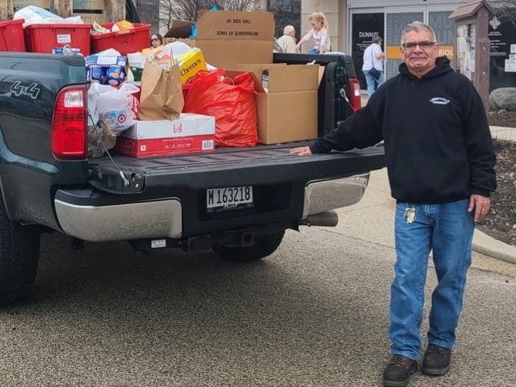 Dunn Museum visitors donated more than 2,200 pounds of food to benefit the Libertyville Township Food Pantry. Alex Rodriguez from the township loaded more than 40 bins filled with food from the Museum. 