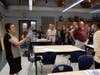 Teachers stand up to participate in an energizer for responsive classroom instruction. 