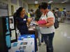 Pattie Cavalli, education/awareness prevention coordinator for Network of Victim Assistance (NOVA), speaks with a parent about NOVA’s services. 