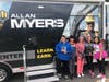 Students pose with the Allan Myers mobile training center