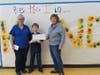 Student Council Advisor Cathy Ivins and Student Council President Ayden Brenner proudly present a check for $1,000 to Nancy Shanberg of the ERA Food Pantry. 