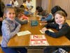 Students color cards and write personalized messages for the Gift of Hope packages. 