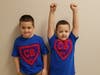 Two brothers dressed up as “little Superman” Christopher Becker, the inspiration behind Superhero Day.