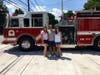 Dave Case with his two daughters, Emily (on the left) and Megan (on the right), out front of the Rocky Hill Fire Department.