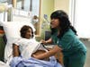 Angela Friend, DCIU Practical Nursing Program student, practices patient care with one of the program's new Laerdal mannequins, which replicate childbirth scenarios.