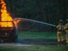 Glendora Fire Company firefighters participate in live burn training, extinguishing a vehicle fire.
