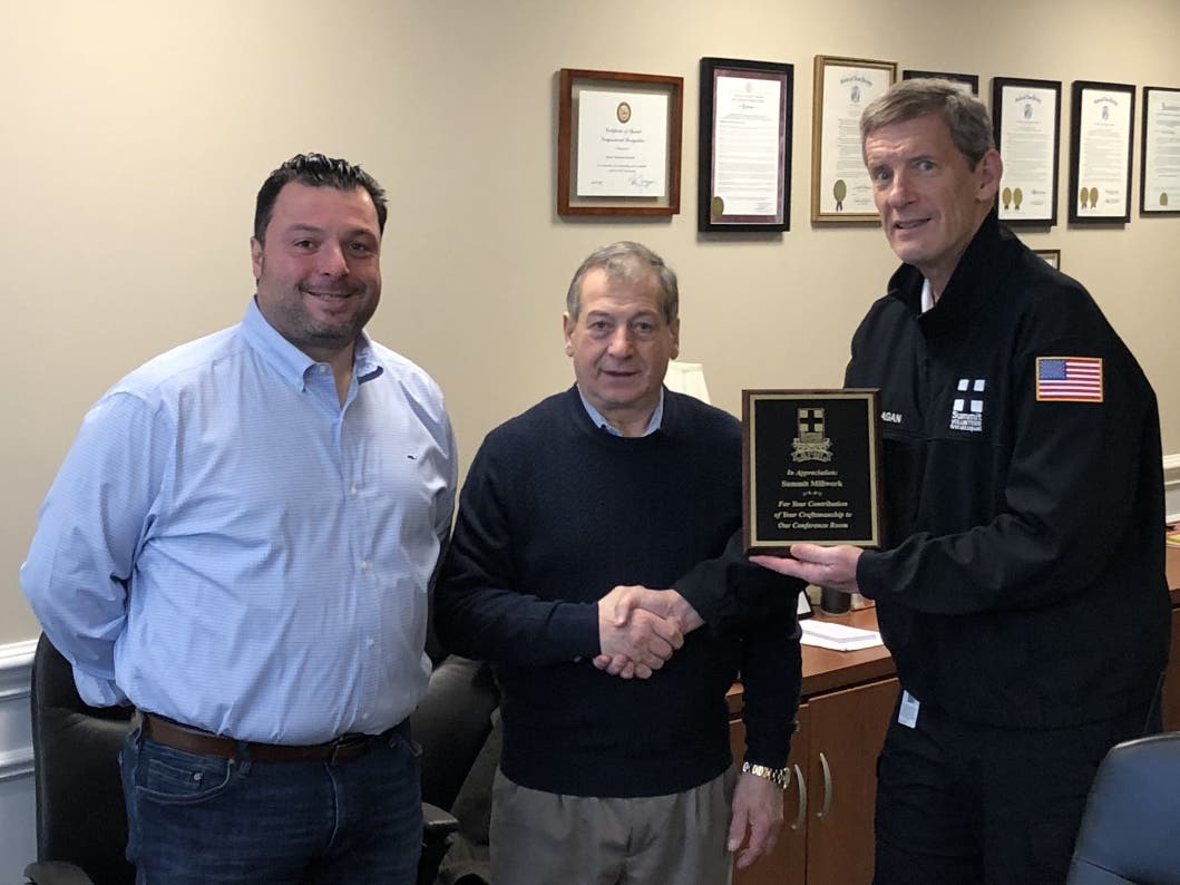 Squad President Bob Flanagan presents a plaque to Aldo and Nick Curiale of Summit Millwork & Supply.