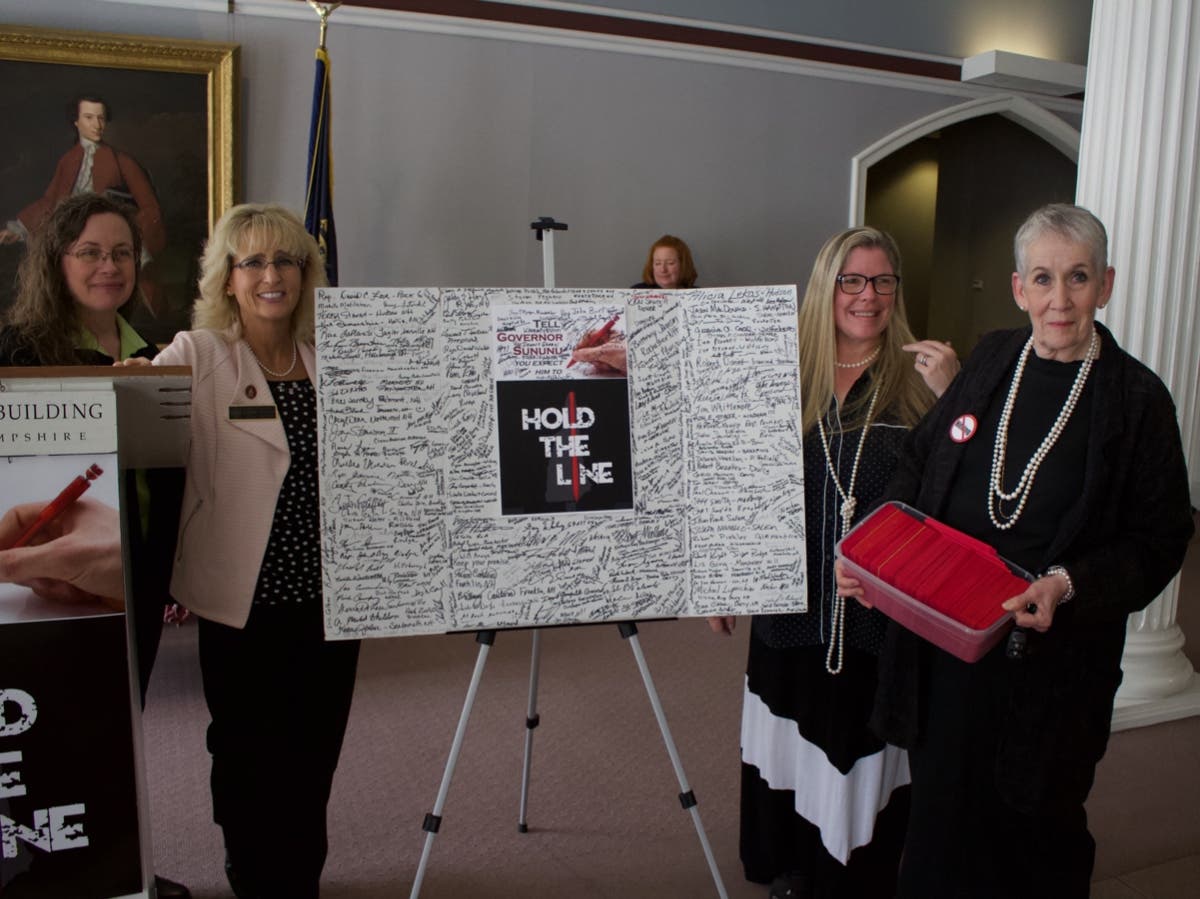 Michelle Levell, Jeanine Notter, Kimberly Morin, and Susan Olsen gave cards to Sununu requesting vetos on gun bills. 