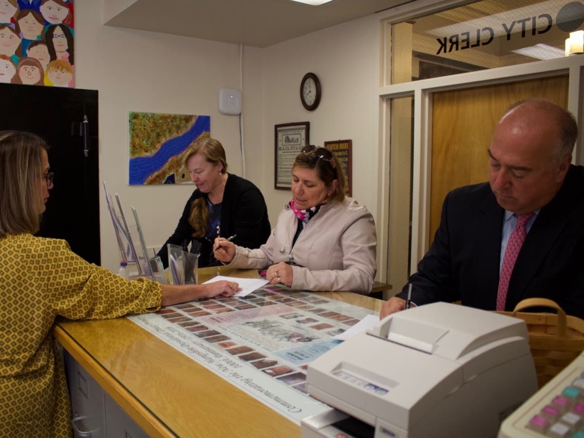 Concord City Clerk Janice Bonenfant, left, speaks with Ward 3 City Councilor Jennifer Kretovic, center, about signing up to run in 2019. Meredith Hatfield, left, of Ward 4, and Concord Mayor Jim Bouley, were all the first to signup on Sept. 6. 
