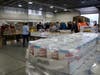 Volunteers prepare Capital Region Food Program holiday baskets at the National Guard Armory in Concord on Dec. 17. 