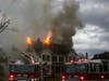 Firefighters battle a fire at a multi-family home on North State Street May 15.