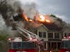 Firefighters battle a fire at a multi-family home on North State Street May 15.
