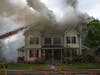 Firefighters battle a fire at a multi-family home on North State Street May 15.