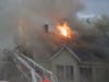 Firefighters battle a fire at a multi-family home on North State Street May 15.