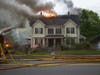 Firefighters battle a fire at a multi-family home on North State Street May 15.