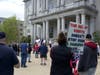 Pastor David Berman preaches from the steps of the Statehouse in Concord May 16 as others look on. 