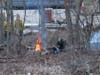 A fire at a campsite in the woods behind the Kimball-Jenkins Estate and near I-393 overpass on April 14. 