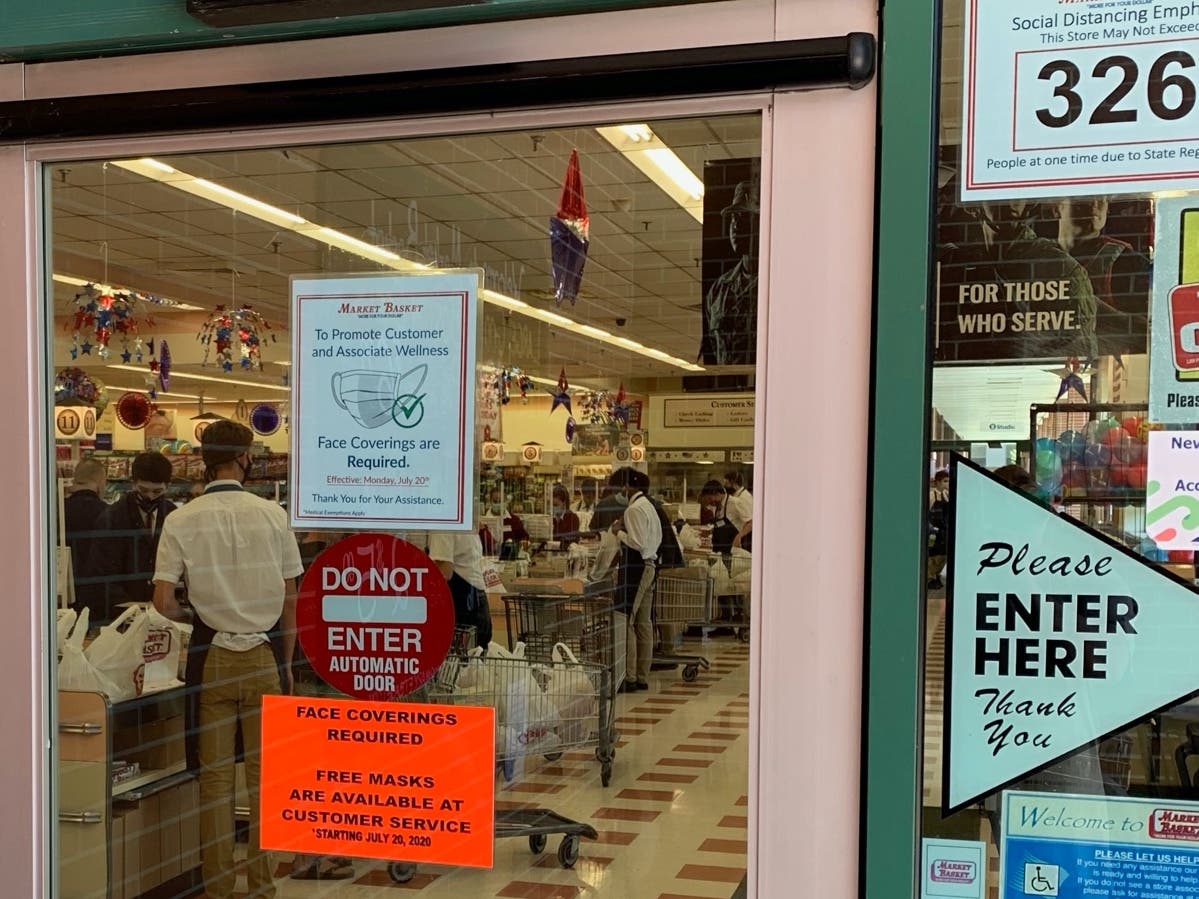 Notices on the doors of Market Basket locations in Concord tell customers that face coverings or masks will be required of everyone being July 20.