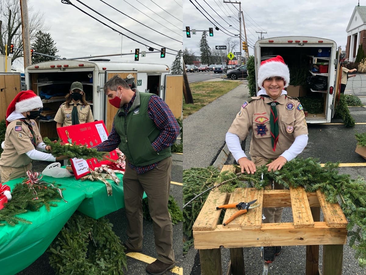 Exeter Scouts sold their customized wreaths recently. Seamus Bihari, right, is pictured making a wreath. 