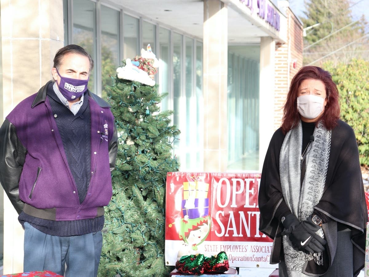 Lori Weaver, right, the deputy commission of the New Hampshire Department of Health and Human Services, and Rich Gulla, the president of SEA/SEIU Local 1984 celebrate another year of Operation Santa Claus.
