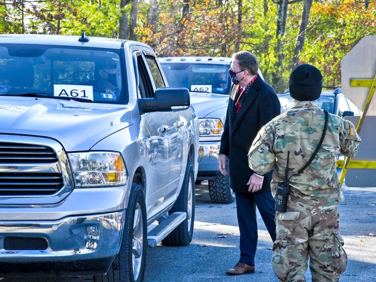 Gov. Chris Sununu visited with people lined up to get the first vaccinations as part of New Hampshire's Phase 1B COVID-19 plan in Londonderry on Jan. 26. 