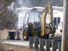 A backhoe at Shea Farm caught on fire and flames spread to a nearby garage and brush, too, on March 22.