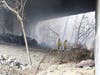 Witnesses reported hearing explosions and black smoke billowing from underneath the Water Street bridge on April 8 after another homeless camp fire in Concord.