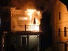 Fire destroyed a four-unit condominium on Merrimack Street on April 28. This photo captured the fire on a second-story deck before firefighters arrived.