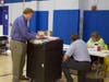 John Williams, the Ward 4 moderator, grabs the tape and results from the AccuVote Optical scanning machine on July 13. 