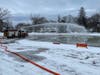Off-duty Concord firefighters spray water on White Park Pond on Jan. 9 to both melt the snow and add icy layers in preparation for freezing and later, skating.